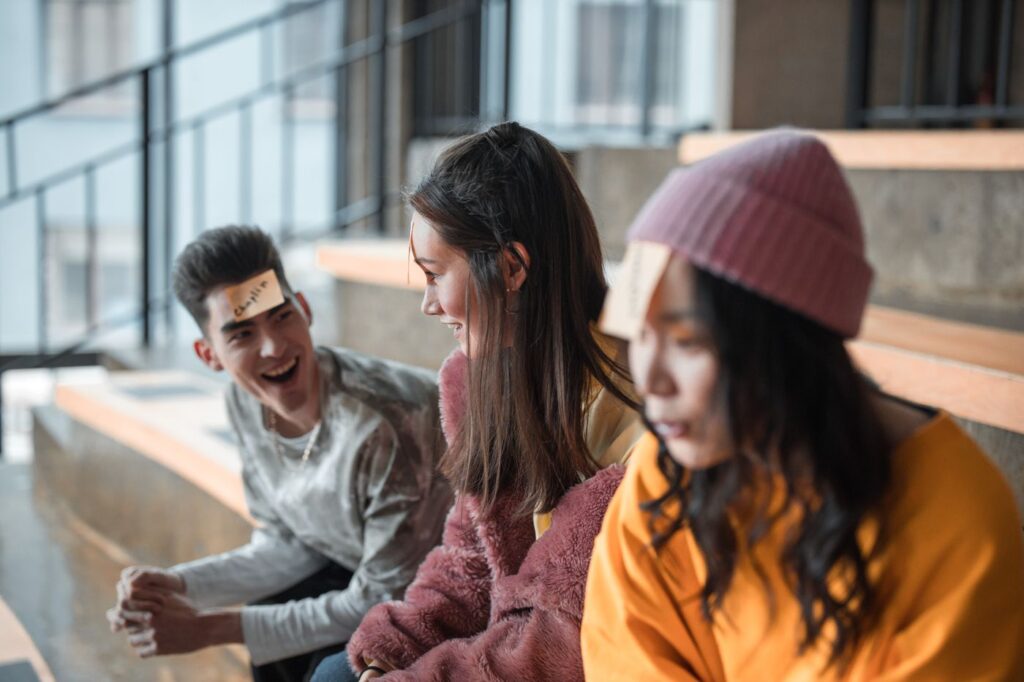 Group of friends laughing while playing a trivia game