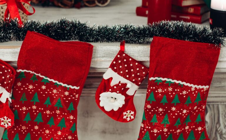 Colorful Christmas stockings hanging on a decorated mantel