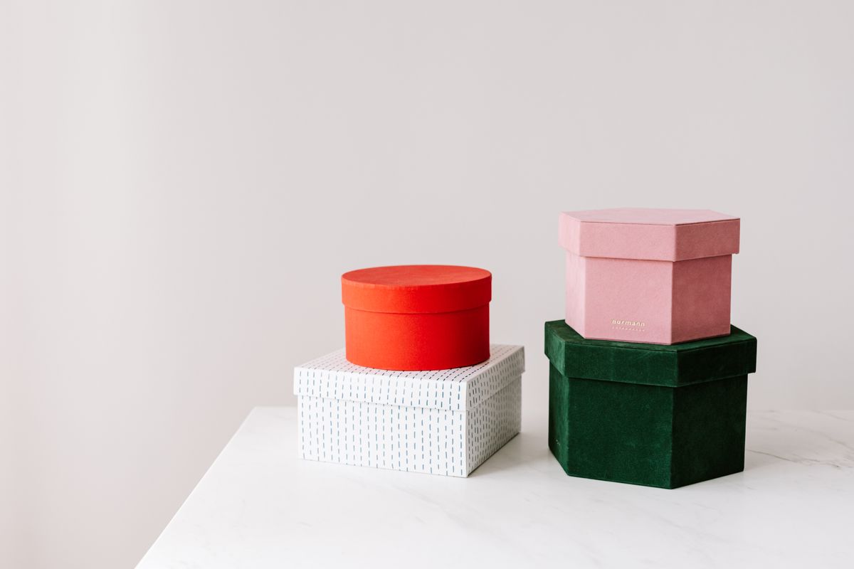 Colorful stack of wrapped gift boxes, budget-friendly gift ideas from Nothing Over Ten